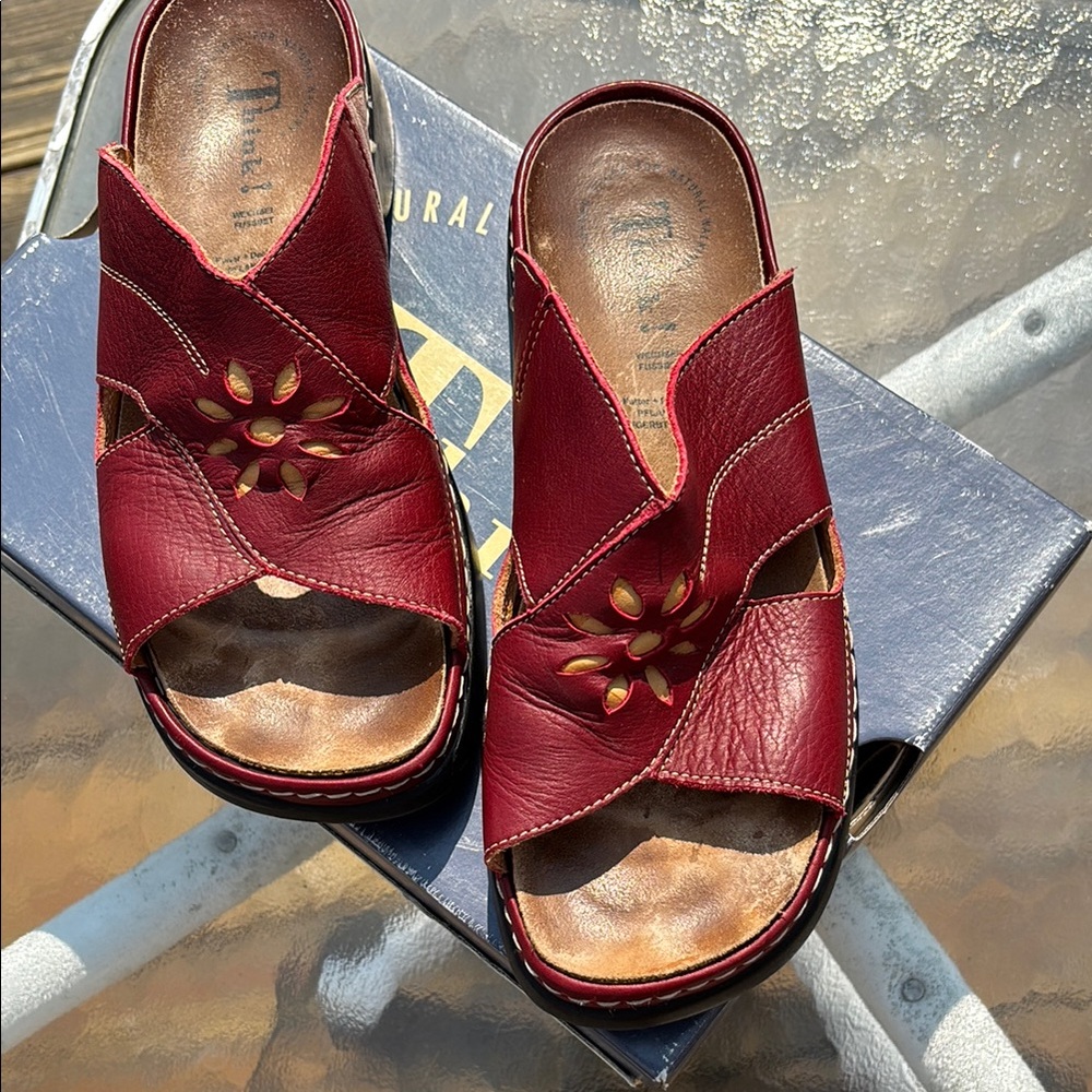 Think! Walk out in style with red leather sandals & beautiful detail.